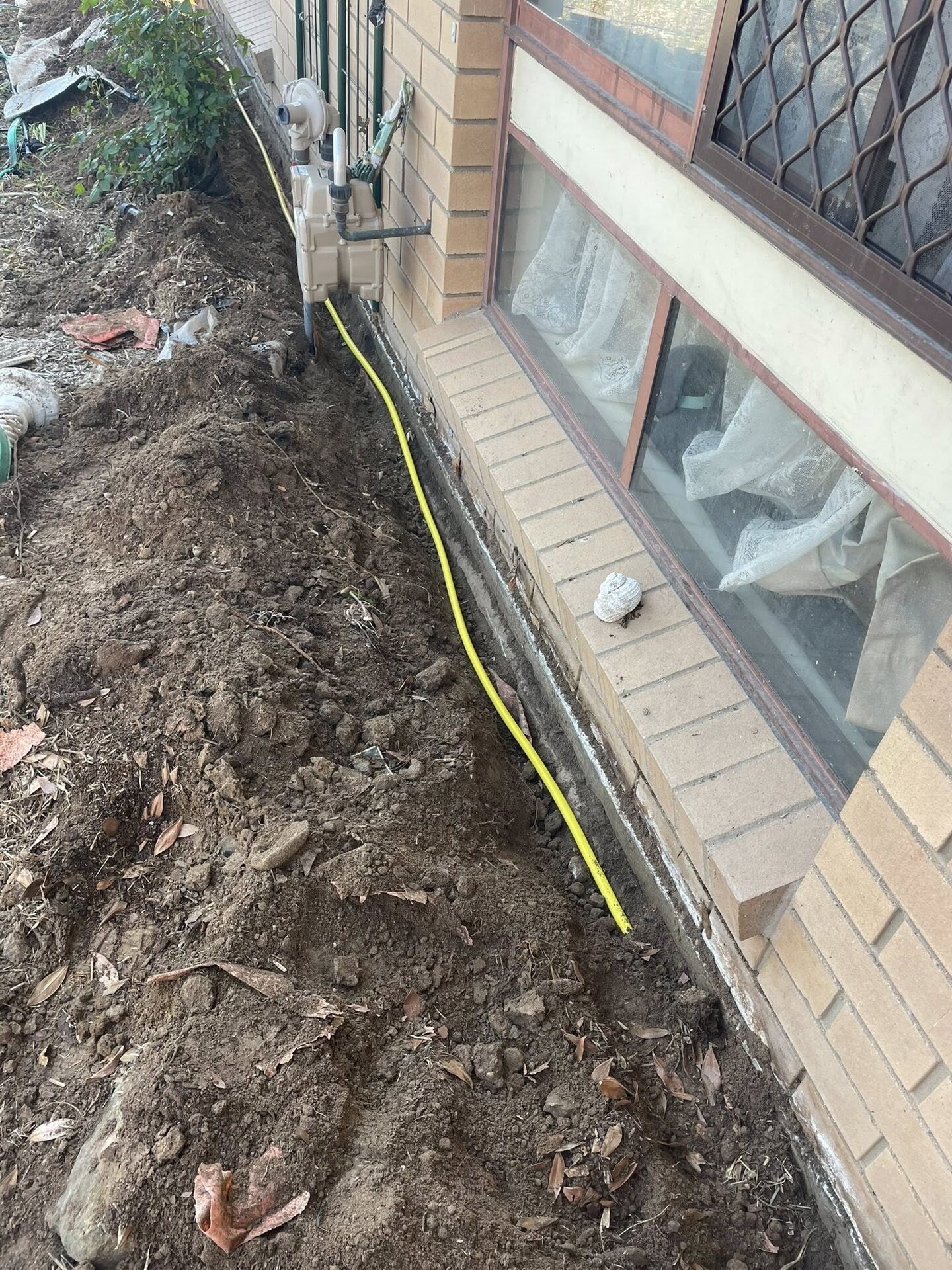 Termite reticulation system being installed around a residential foundation